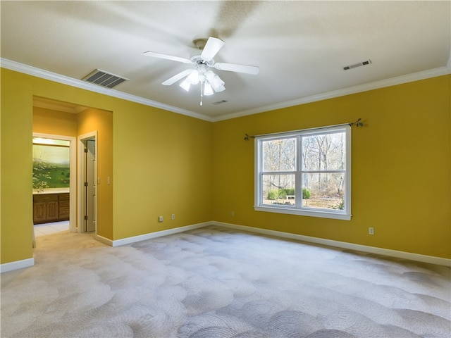 carpeted empty room with ceiling fan and ornamental molding