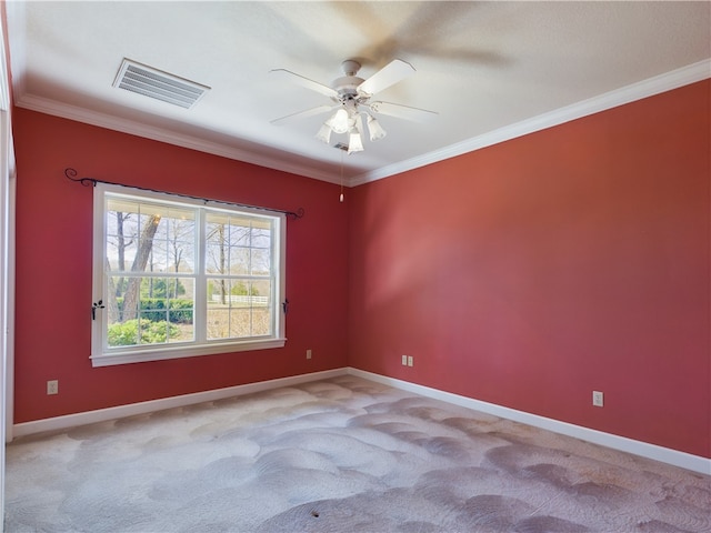 carpeted empty room with ceiling fan and crown molding