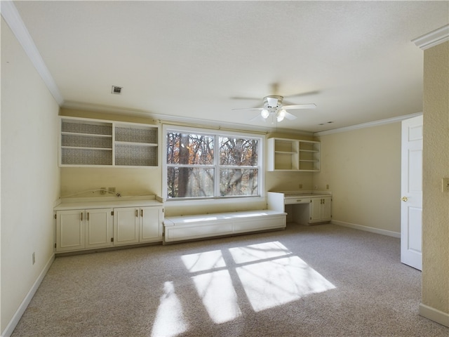 interior space with ceiling fan, crown molding, and light carpet