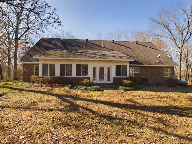 back of house featuring a lawn and french doors