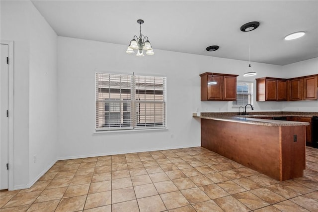 kitchen featuring pendant lighting, sink, a notable chandelier, light tile patterned flooring, and kitchen peninsula