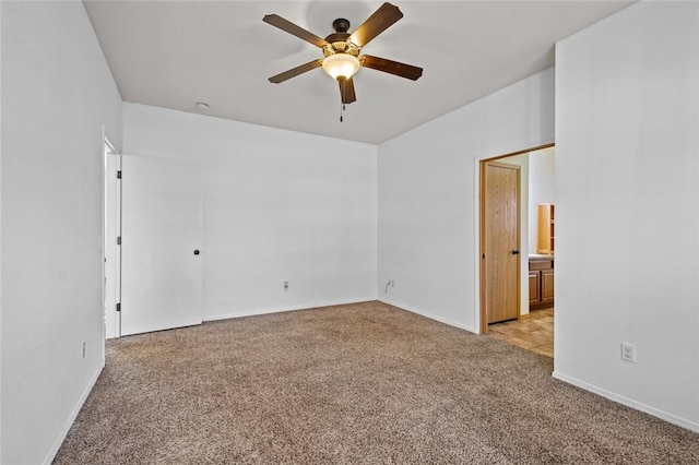 carpeted spare room with ceiling fan