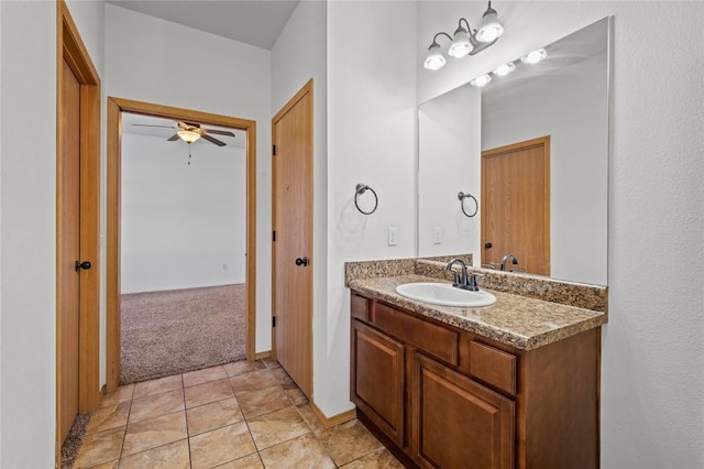 bathroom with tile patterned flooring, ceiling fan, and vanity