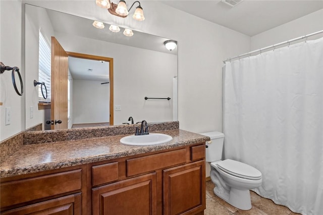 bathroom featuring tile patterned flooring, vanity, and toilet