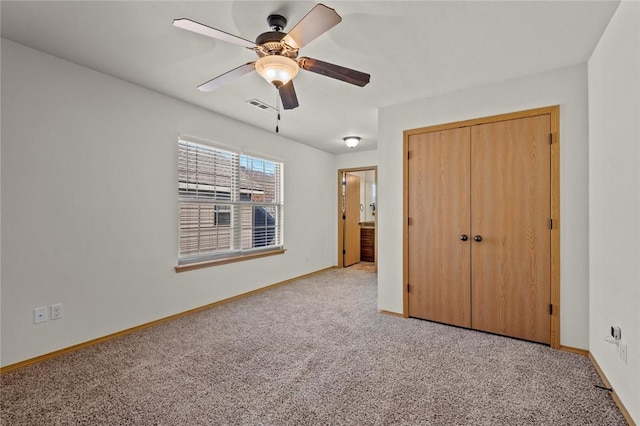 unfurnished bedroom featuring light carpet, a closet, and ceiling fan