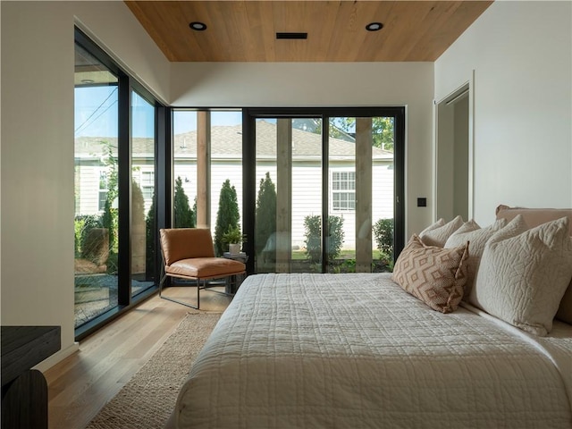 bedroom with wood ceiling, access to outside, and light wood-type flooring