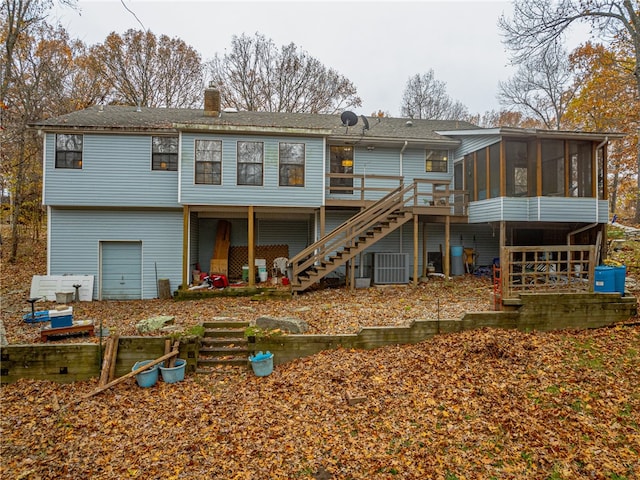 rear view of house with central AC, a sunroom, and a deck