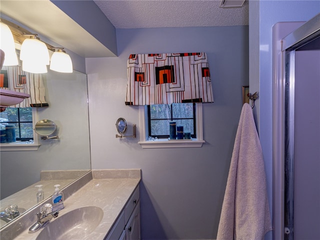 bathroom with vanity and a textured ceiling