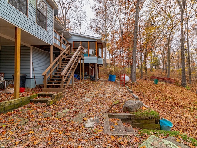 view of yard with a wooden deck and a sunroom