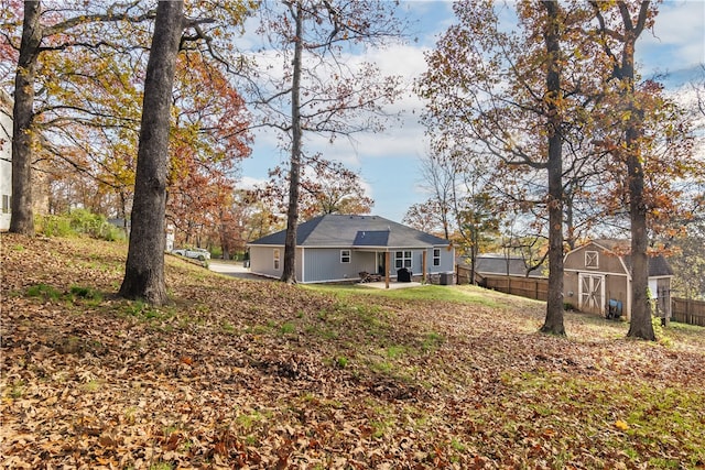 view of yard featuring a patio area and a storage shed