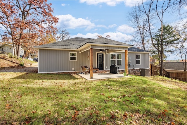 back of property with ceiling fan, cooling unit, a patio area, and a yard