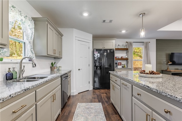 kitchen featuring dark hardwood / wood-style flooring, black fridge, sink, dishwasher, and gray cabinets