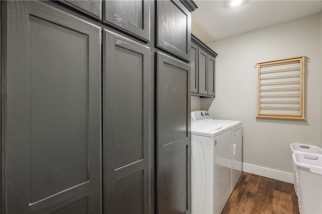 laundry area with washer and clothes dryer, cabinets, and dark wood-type flooring