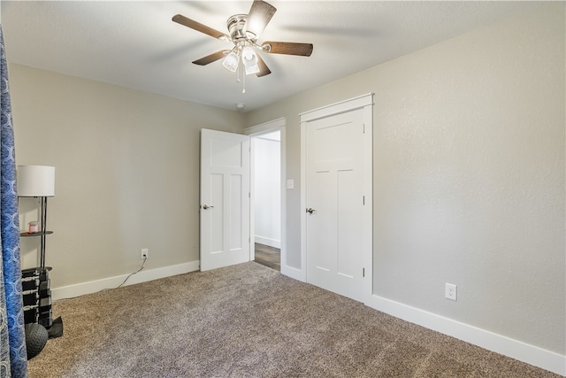 unfurnished bedroom with ceiling fan and carpet floors