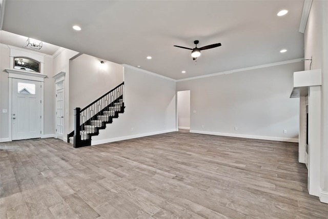 unfurnished living room featuring ceiling fan, crown molding, and light hardwood / wood-style flooring