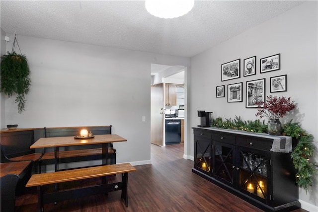 dining room with dark hardwood / wood-style flooring and a textured ceiling