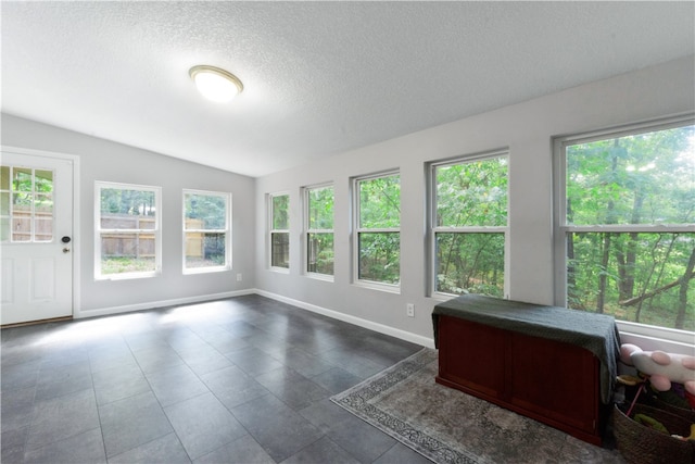 unfurnished sunroom featuring a wealth of natural light and lofted ceiling