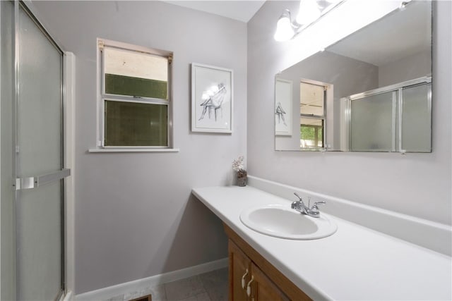 bathroom featuring tile patterned floors, vanity, and walk in shower