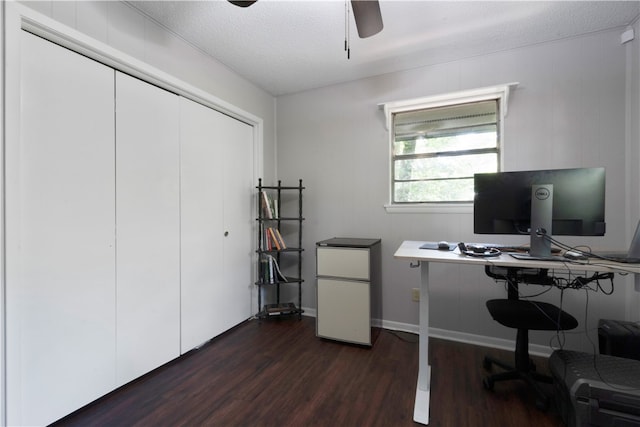 office featuring a textured ceiling, ceiling fan, and dark wood-type flooring