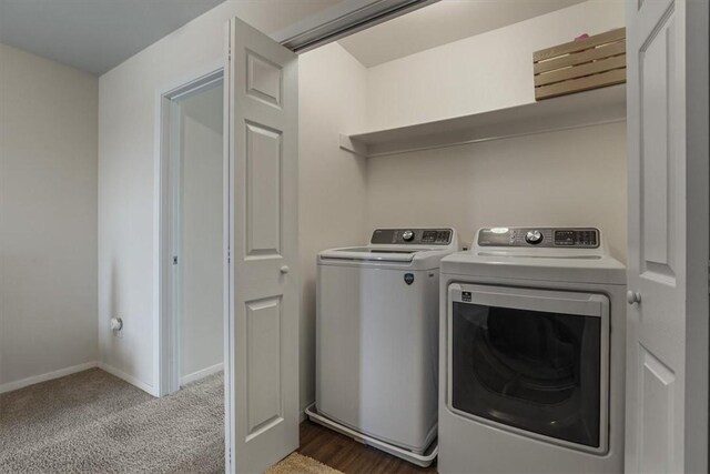 clothes washing area featuring carpet flooring and washer and dryer