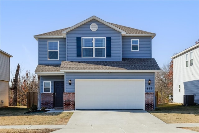 front of property featuring a front yard, a garage, and cooling unit