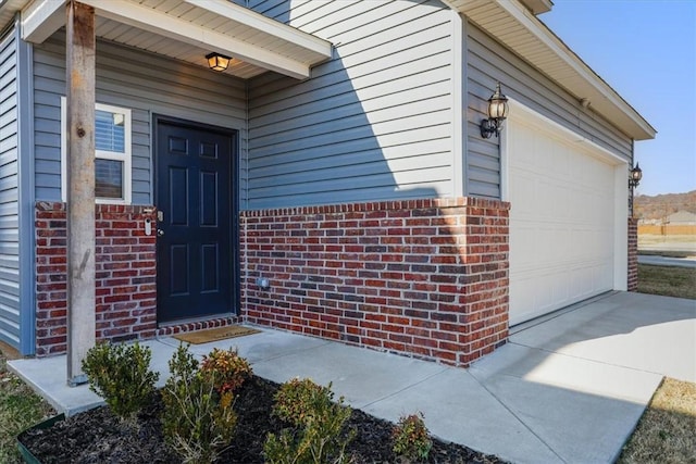 doorway to property with a garage