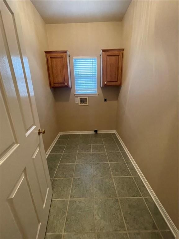 laundry room featuring washer hookup, electric dryer hookup, cabinets, and dark tile patterned floors