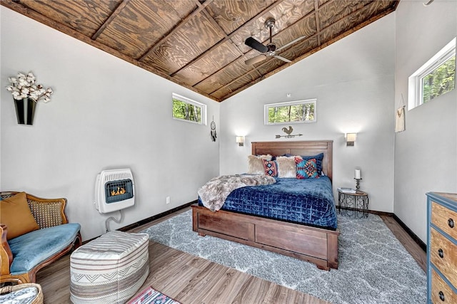 bedroom with wood ceiling, lofted ceiling, dark wood-type flooring, and heating unit