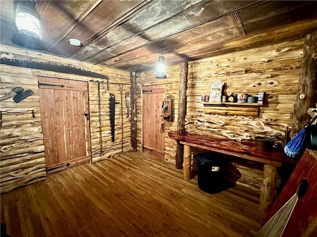 interior space featuring wood-type flooring, wooden walls, and wood ceiling