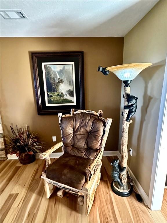 living area with hardwood / wood-style floors