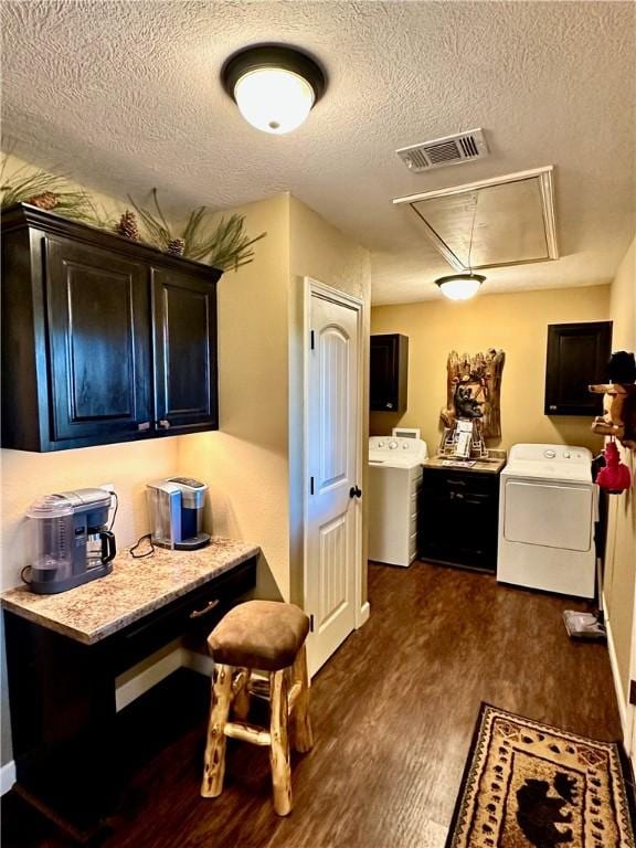 329 Bradley Ridge Rd, Marshall, AR 72650 - kitchen with dark wood-type flooring, a textured ceiling, light countertops, and washing machine and clothes dryer