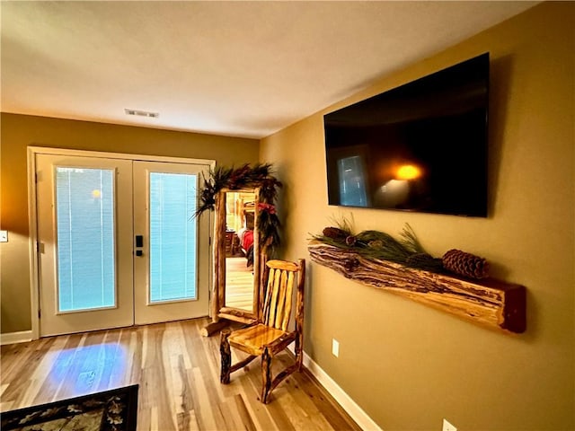 doorway with french doors and light hardwood / wood-style floors