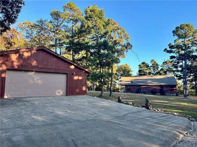 exterior space with a garage and an outbuilding