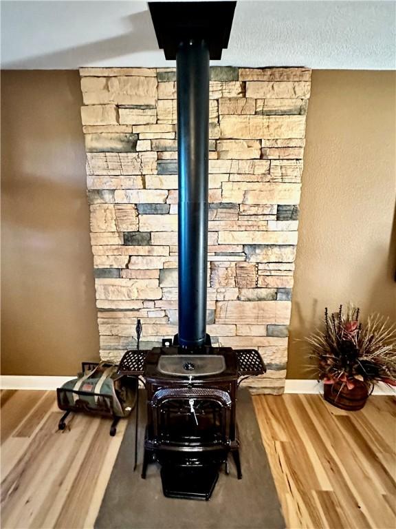329 Bradley Ridge Rd, Marshall, AR 72650 - detailed view of wood finished floors and a wood stove