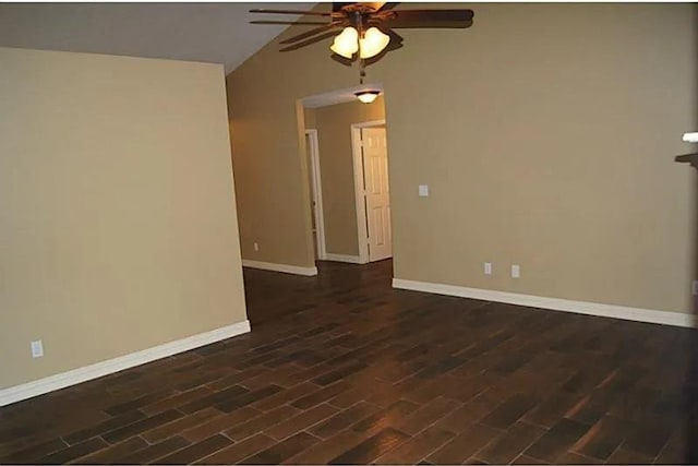 unfurnished room featuring lofted ceiling, ceiling fan, and dark wood-type flooring