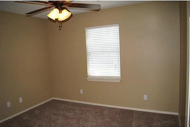 carpeted spare room with ceiling fan