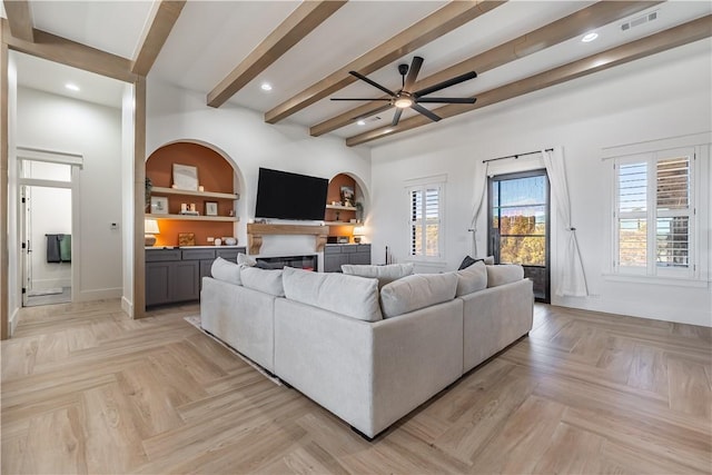 living area with visible vents, baseboards, beam ceiling, recessed lighting, and a ceiling fan