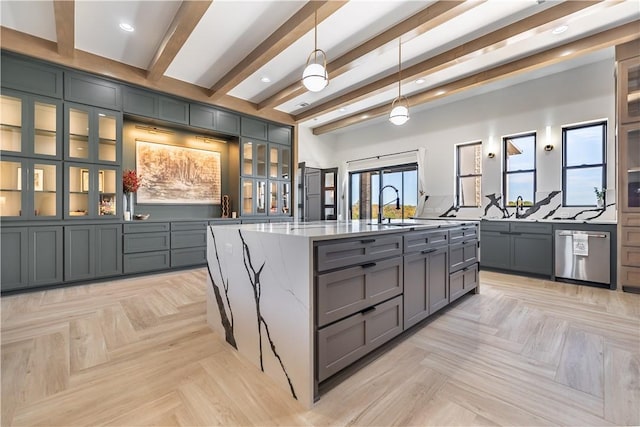 kitchen with beamed ceiling, dishwasher, light stone counters, gray cabinets, and a sink