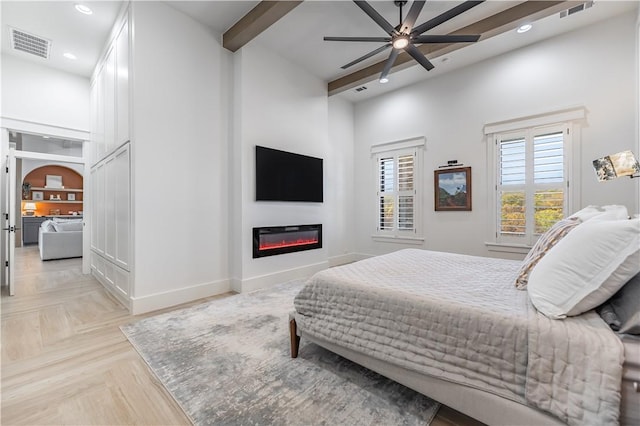 bedroom featuring visible vents, baseboards, beam ceiling, recessed lighting, and a glass covered fireplace