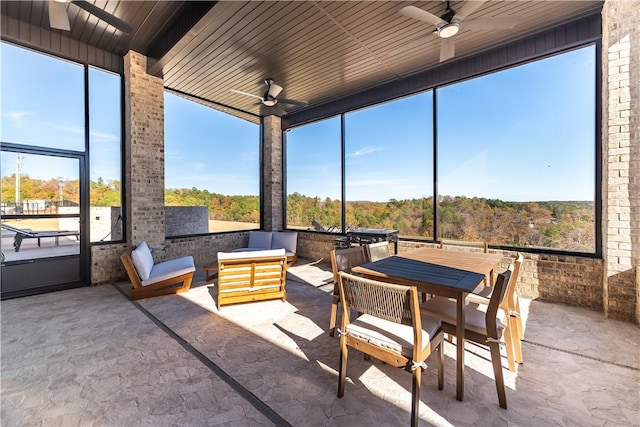 sunroom / solarium featuring wooden ceiling and a ceiling fan