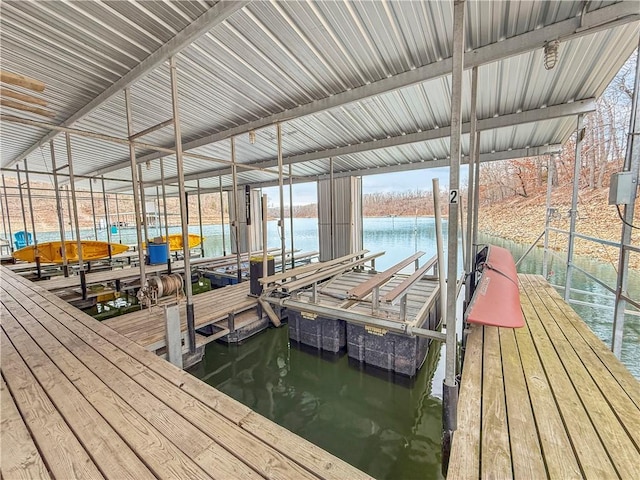 dock area with boat lift and a water view