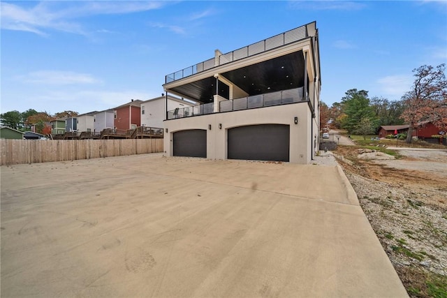 exterior space with a balcony and a garage