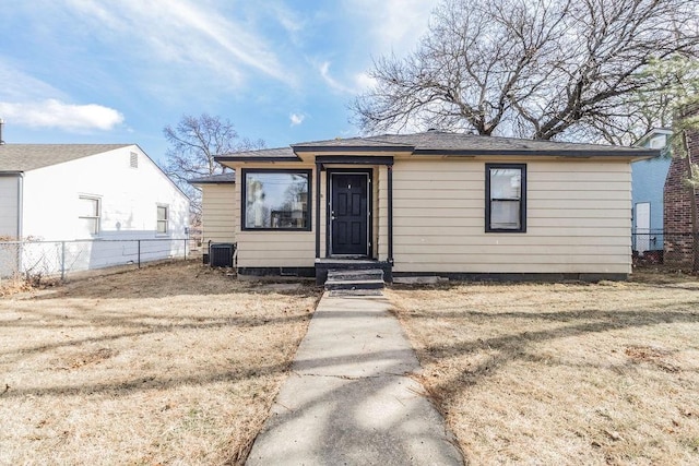 view of front of home featuring a front yard and cooling unit