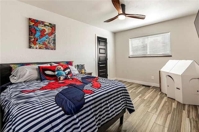 bedroom with light hardwood / wood-style floors and ceiling fan