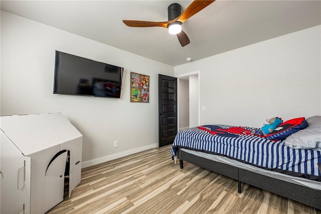 bedroom with ceiling fan and hardwood / wood-style floors