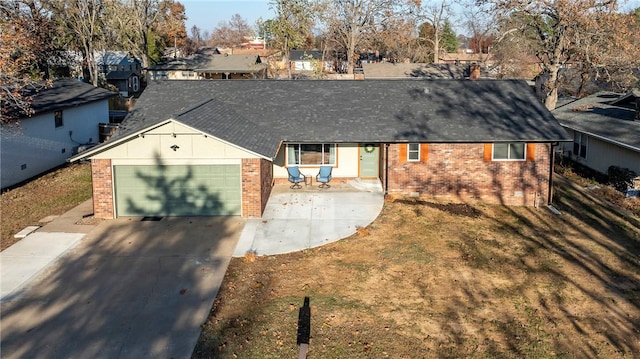 ranch-style house featuring a front lawn and a garage