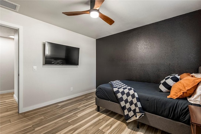 bedroom with hardwood / wood-style flooring and ceiling fan