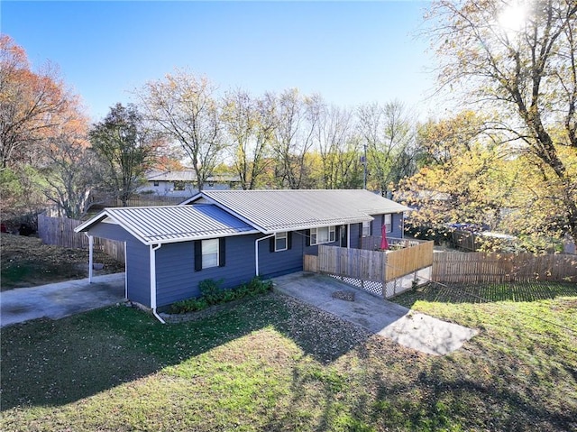 ranch-style house featuring a front yard and a carport