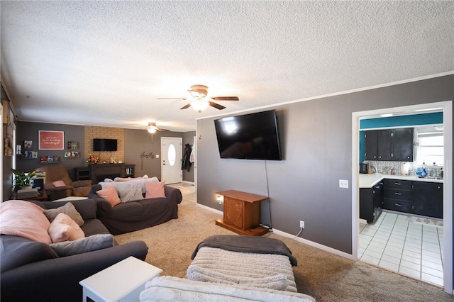 living room featuring carpet, ceiling fan, crown molding, and a textured ceiling