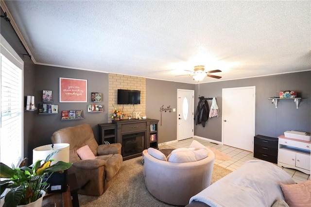 living room with a textured ceiling, ceiling fan, light tile patterned floors, and a fireplace